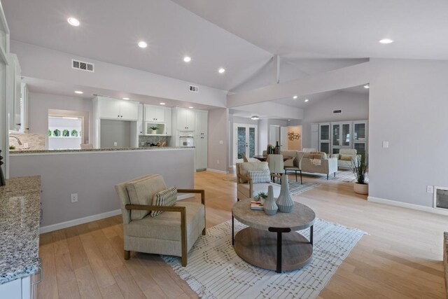 8702 Willowick Dr, Austin, TX 78759 - living area with lofted ceiling, light wood-style floors, and recessed lighting