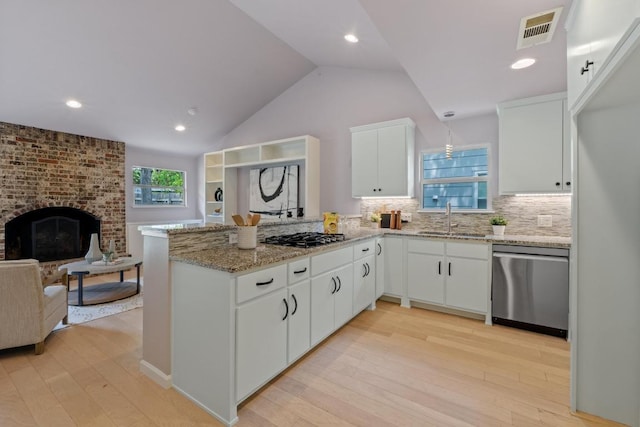 8702 Willowick Dr, Austin, TX 78759 - kitchen featuring dishwasher, a peninsula, light wood-style floors, decorative backsplash, and white cabinetry