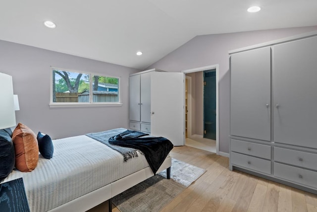 8702 Willowick Dr, Austin, TX 78759 - bedroom featuring lofted ceiling, light wood finished floors, recessed lighting, and multiple closets