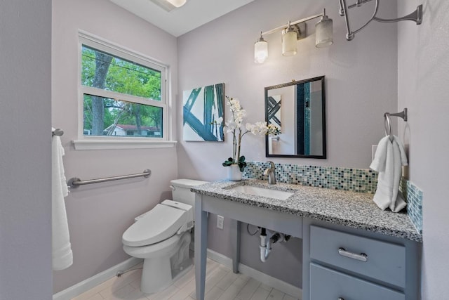 8702 Willowick Dr, Austin, TX 78759 - half bathroom featuring a sink and decorative backsplash