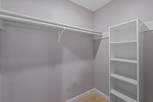 8702 Willowick Dr, Austin, TX 78759 - walk in closet with wood finished floors