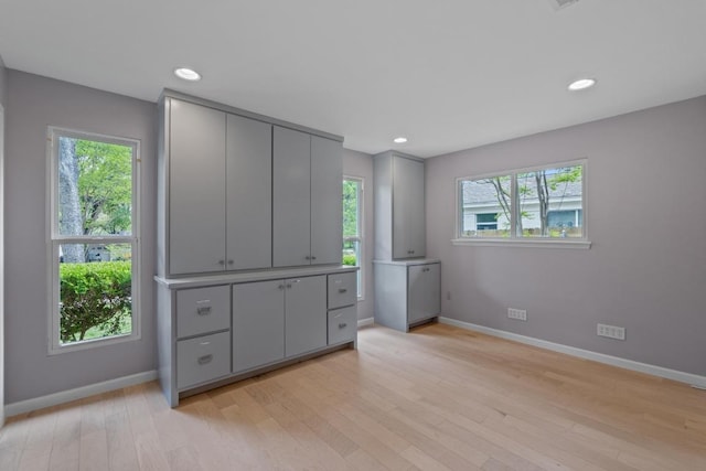 8702 Willowick Dr, Austin, TX 78759 - unfurnished bedroom with light wood finished floors and recessed lighting