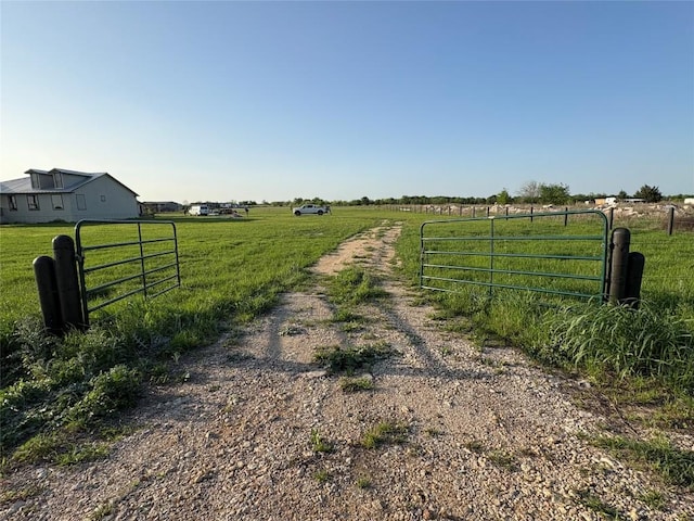 581 County Road 462, Elgin, TX 78621 - exterior space featuring driveway, a gate, a rural view, and a gated entry