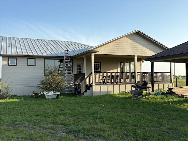 581 County Road 462, Elgin, TX 78621 - back of property with a lawn and metal roof