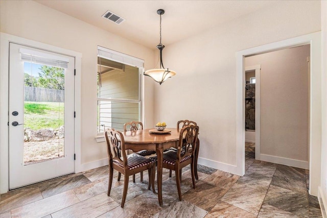 dining room with baseboards and visible vents