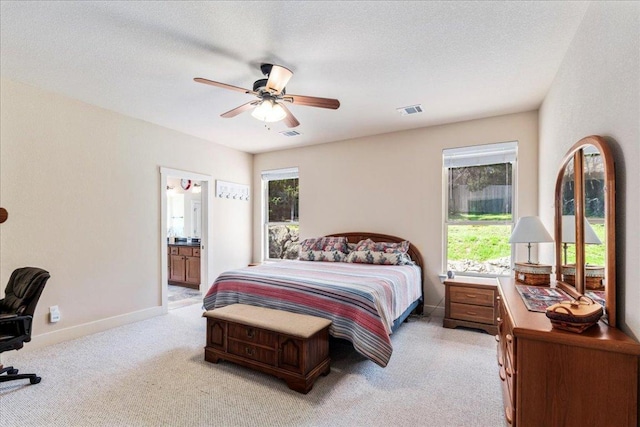bedroom with baseboards, a textured ceiling, multiple windows, and visible vents