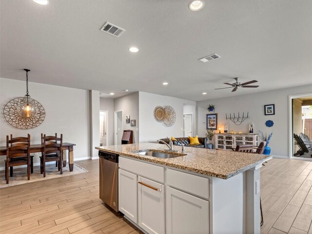 4104 Porter Farm Rd, Georgetown, TX 78628 - kitchen featuring a sink, visible vents, light wood-style floors, and dishwasher
