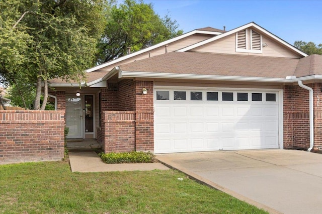 12301 Furrow Cv Unit B, Austin, TX 78753 - view of front facade with a garage, concrete driveway, brick siding, and a shingled roof