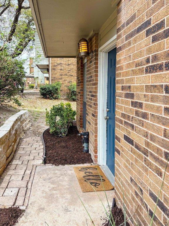 entrance to property with brick siding
