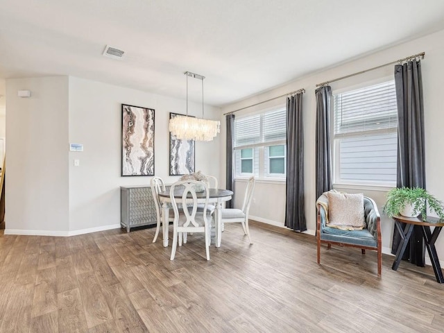 709 Bluffview Dr, Bastrop, TX 78602 - dining space with light wood-style flooring, a chandelier, and baseboards