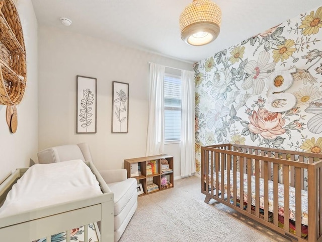 709 Bluffview Dr, Bastrop, TX 78602 - bedroom with light carpet, a crib, and wallpapered walls