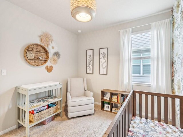 709 Bluffview Dr, Bastrop, TX 78602 - carpeted bedroom featuring a crib and baseboards
