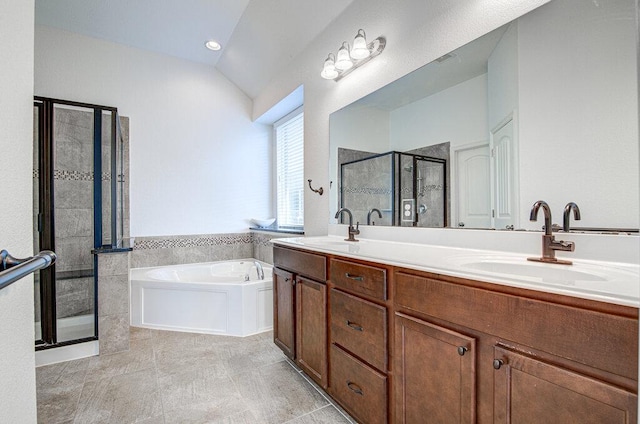 5617 Rio Chama Cv, Austin, TX 78738 - bathroom featuring a stall shower, a garden tub, tile patterned floors, vaulted ceiling, and double vanity