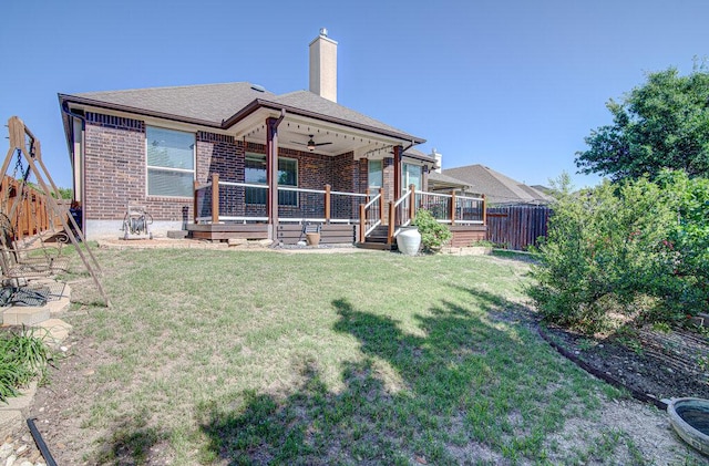 5617 Rio Chama Cv, Austin, TX 78738 - back of property with ceiling fan, brick siding, a fenced backyard, a chimney, and a wooden deck