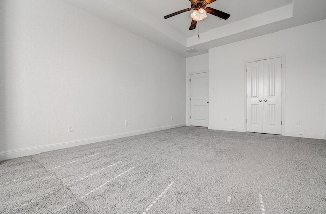 5617 Rio Chama Cv, Austin, TX 78738 - unfurnished bedroom with carpet flooring, a tray ceiling, baseboards, and ceiling fan