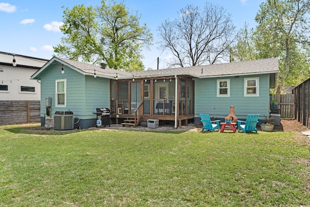 2008 Pequeno St, Austin, TX 78757 - rear view of property with central AC unit, a lawn, a fenced backyard, a sunroom, and roof with shingles