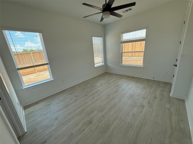 1503 Kit Cir, Austin, TX 78758 - empty room with light wood-style floors and a ceiling fan