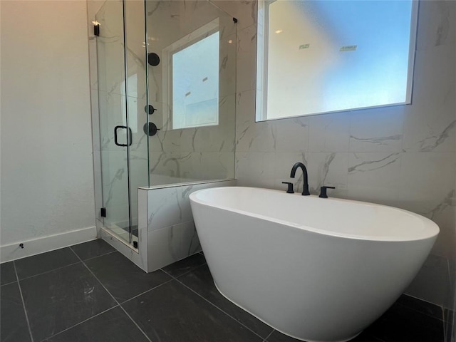1503 Kit Cir, Austin, TX 78758 - full bathroom featuring a marble finish shower, a soaking tub, and tile patterned floors