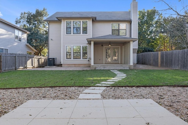 1434 Meadow Pkwy, San Marcos, TX 78666 - rear view of property with central AC unit, a chimney, a fenced backyard, french doors, and a yard