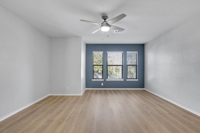 1434 Meadow Pkwy, San Marcos, TX 78666 - unfurnished room with baseboards, ceiling fan, and light wood-style flooring