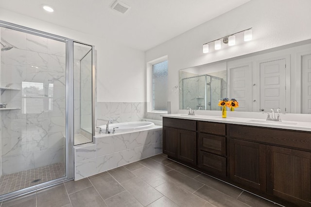 317 Independence Dr, Kyle, TX 78640 - bathroom with a bath, a marble finish shower, double vanity, and tile patterned flooring