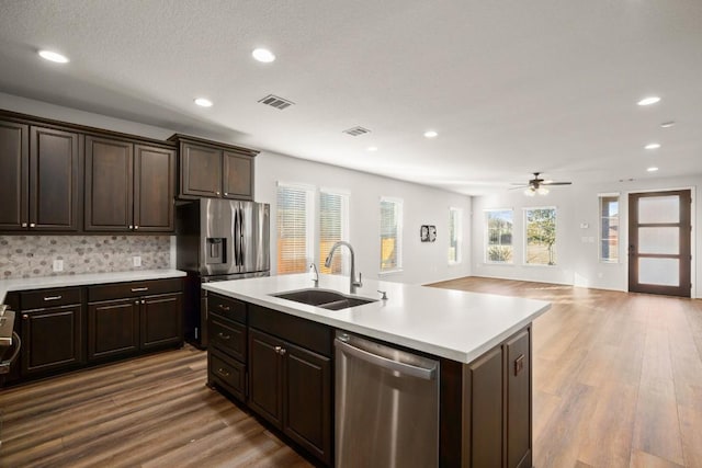 932 Azul Lagoon Dr Unit 18, Leander, TX 78641 - kitchen with stainless steel appliances, a sink, a ceiling fan, light countertops, and recessed lighting