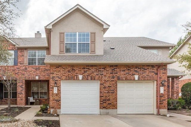 33 Verde Ranch Loop, Leander, TX 78641 - view of front facade with driveway, roof with shingles, a garage, and brick siding
