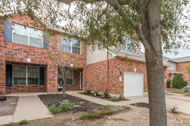 33 Verde Ranch Loop, Leander, TX 78641 - view of front facade with brick siding, a garage, concrete driveway, and stucco siding