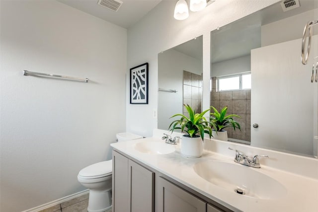 33 Verde Ranch Loop, Leander, TX 78641 - bathroom with toilet, double vanity, tile patterned floors, and baseboards