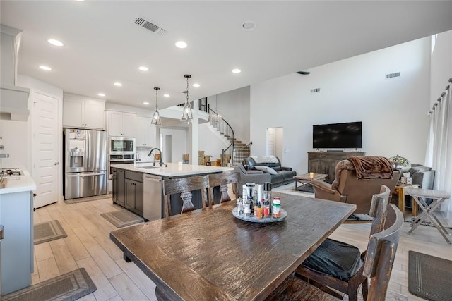 104 Trans Pecos Ct, Georgetown, TX 78628 - dining space featuring stairs, recessed lighting, and light wood-type flooring