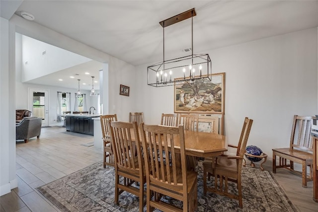 104 Trans Pecos Ct, Georgetown, TX 78628 - dining space with light wood-style floors, a chandelier, and recessed lighting