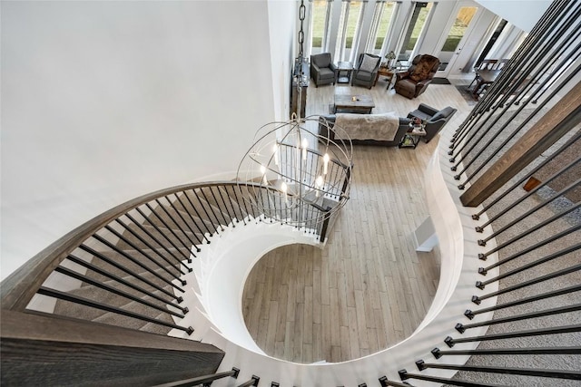 104 Trans Pecos Ct, Georgetown, TX 78628 - stairs with hardwood / wood-style flooring and a chandelier