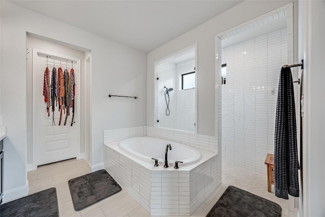 104 Trans Pecos Ct, Georgetown, TX 78628 - full bath featuring a garden tub, vanity, tiled shower, a spacious closet, and tile patterned floors