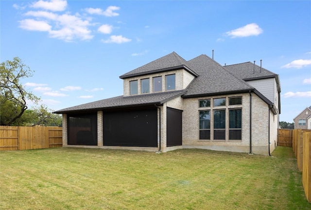 104 Trans Pecos Ct, Georgetown, TX 78628 - rear view of house with a fenced backyard, a sunroom, and a shingled roof