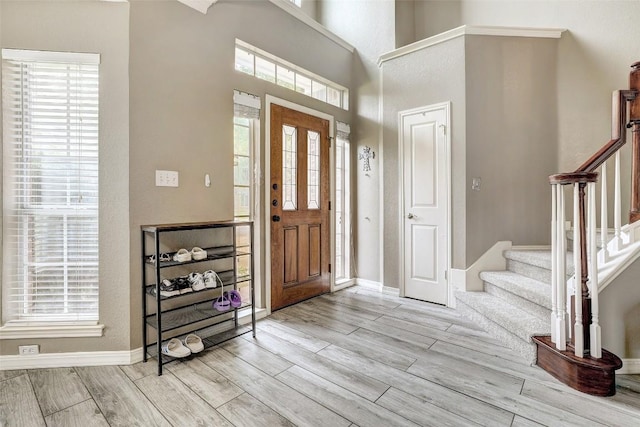 30003 Oakland Hills Dr, Georgetown, TX 78628 - entrance foyer with light wood finished floors, stairway, healthy amount of natural light, and a towering ceiling