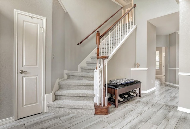 30003 Oakland Hills Dr, Georgetown, TX 78628 - staircase featuring wood finished floors and a high ceiling