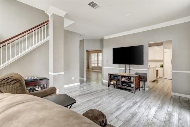 30003 Oakland Hills Dr, Georgetown, TX 78628 - living area with stairs, light wood-style flooring, and crown molding