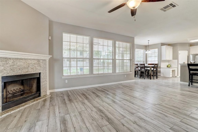 30003 Oakland Hills Dr, Georgetown, TX 78628 - living room with a ceiling fan, light wood-type flooring, and a fireplace