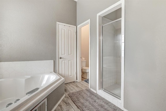 30003 Oakland Hills Dr, Georgetown, TX 78628 - full bath with a bath, a shower stall, wood finished floors, and a textured wall