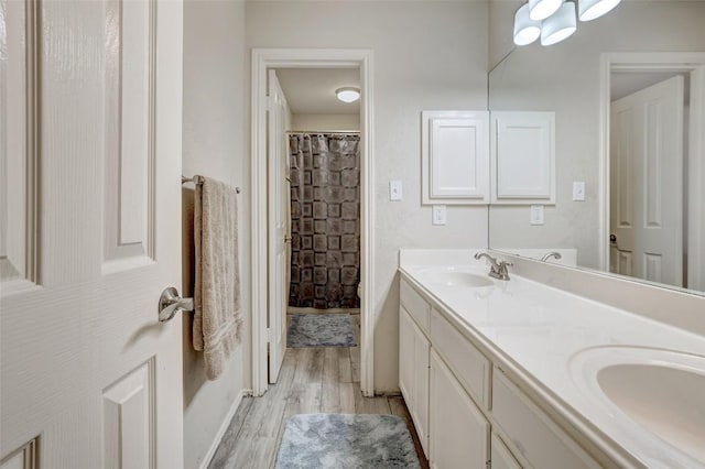 30003 Oakland Hills Dr, Georgetown, TX 78628 - full bath with wood finished floors, double vanity, and curtained shower