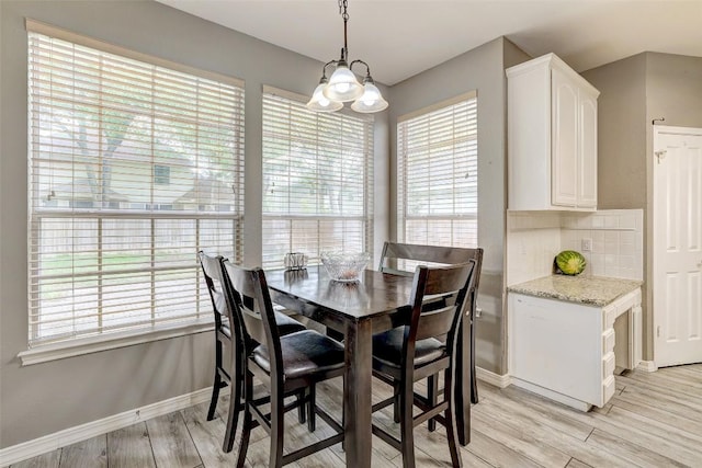 30003 Oakland Hills Dr, Georgetown, TX 78628 - dining room featuring light wood-type flooring and a chandelier