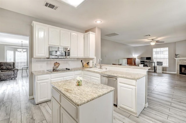 30003 Oakland Hills Dr, Georgetown, TX 78628 - kitchen with open floor plan, appliances with stainless steel finishes, a ceiling fan, a center island, and recessed lighting