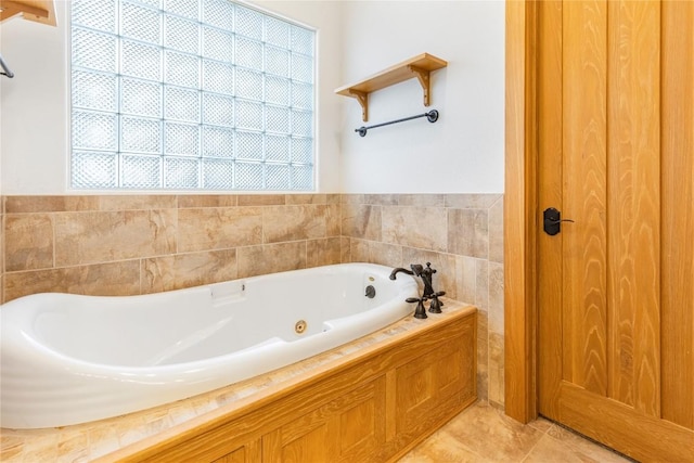 bathroom with tile patterned floors and a jetted tub