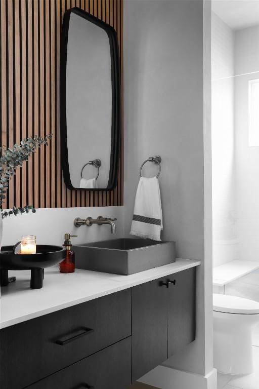 1105 W Monroe St, Austin, TX 78704 - bathroom with wallpapered walls, toilet, and vanity