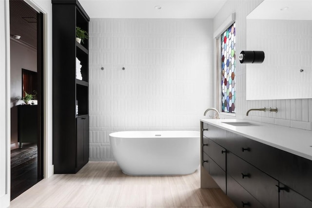 1105 W Monroe St, Austin, TX 78704 - bathroom with tile walls, a freestanding tub, and vanity