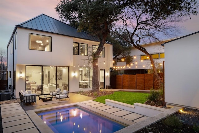1105 W Monroe St, Austin, TX 78704 - back of house with a standing seam roof, an outdoor living space, stucco siding, central air condition unit, and metal roof