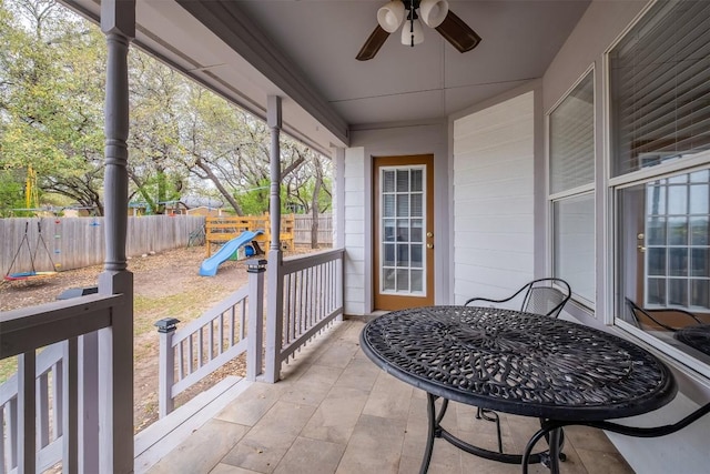view of patio / terrace featuring a ceiling fan, a fenced backyard, and a playground