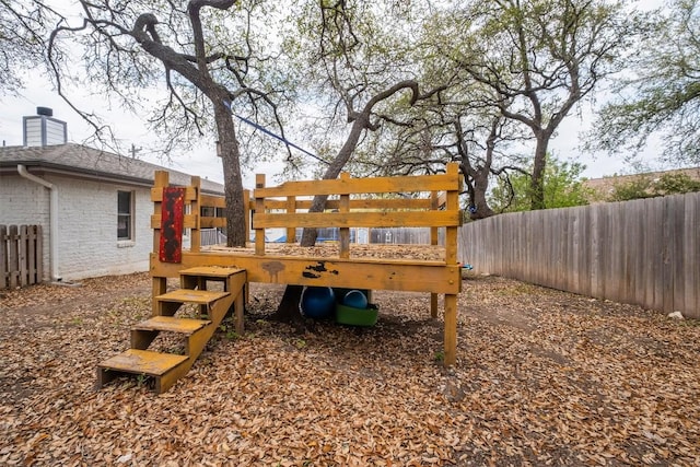 view of yard featuring a playground and fence