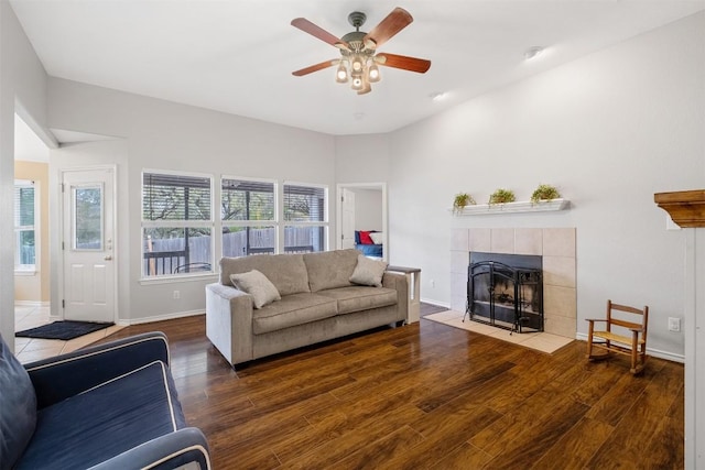7900 Bar K Ranch Rd, Lago Vista, TX 78645 - living area with a tiled fireplace, wood finished floors, baseboards, and ceiling fan