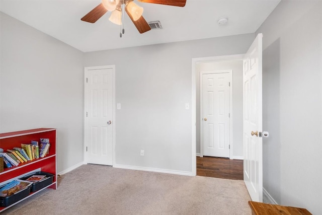bedroom featuring carpet floors, a ceiling fan, visible vents, and baseboards